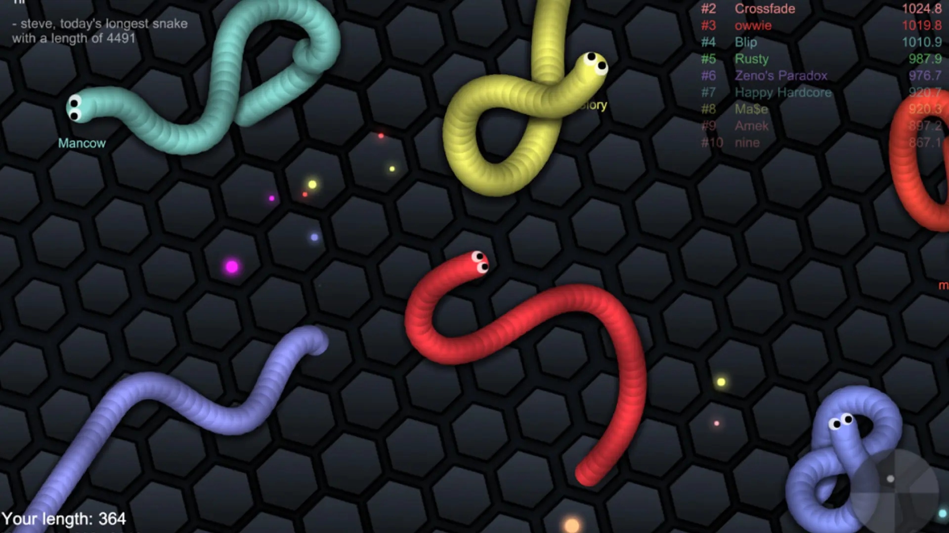 Игровой процесс Slither.io: змеи собирают светящиеся частицы на арене